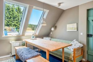 a dining room with a table and a couch at Das Falken Nest in Eisenbach +88 photos
