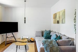a living room with a couch and a tv at Fewo Stembers in Heideck