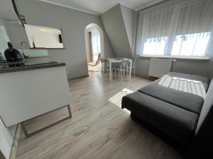 a living room with a bed and a kitchen at Rafa in Rowy