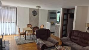 a living room with a table and chairs at DSM & Victory in Plužine