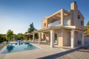 a villa with a swimming pool and a house at Villa Andrionas Private Pool & Total Privacy in Corfu