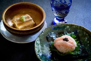 a plate of food with sushi and a bowl of soup at Kocho in Kaga