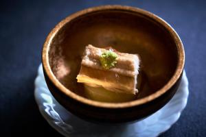a bowl of food with a piece of broccoli in it at Kocho in Kaga