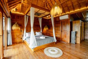 a bedroom with a bed in a wooden room at Rana Suite in Ubud +82 photos