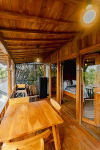 a wooden room with a wooden table and a bed at Rana Suite in Ubud
