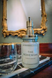 a bottle of the botkin sitting on a table with a mirror at The Bohemian Boutique Guesthouse in Tzaneen +156 photos