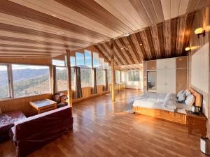 a bedroom with a bed in a room with windows at Orchard Valley Resort in Mai Jūbar +38 photos