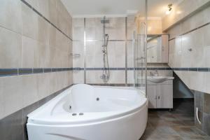 a bathroom with a tub and a shower and a sink at Althea in Skala Potamias +40 photos