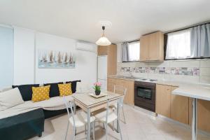 a kitchen and living room with a couch and a table at Althea in Skala Potamias
