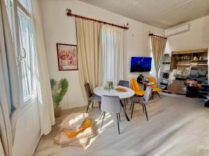 a living room with a table and chairs at TRAVELLERS CORFU TOWN Luxury Suites, Studios & Apartments in Ágios Rókkos