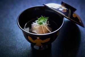 a black bowl of food with a plant in it at Kocho in Kaga +82 photos