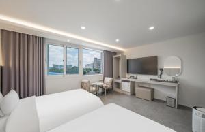 a hotel room with a bed and a desk at Ehan Hotel in Mokpo