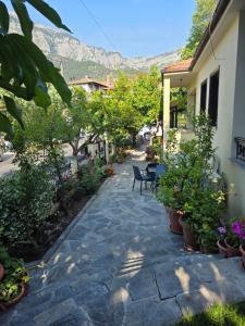 a stone walkway with chairs and plants in front of a house at Althea in Skala Potamias
