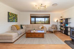 a living room with a couch and a table at Byadbo in Tuncurry