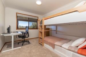 a bedroom with bunk beds and a desk at Byadbo in Tuncurry
