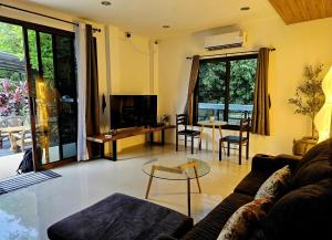 a living room with a couch and a table at Suwaree Garden in Koh Samui
