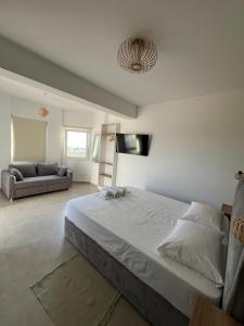a bedroom with a large bed and a couch at Meraki Nikiti in Nikiti