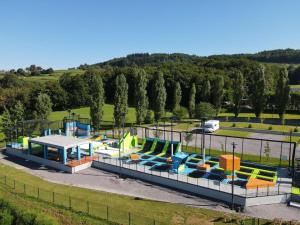 an amusement park with a lot of colorful slides at Glamping resort Dolenjc in Novo Mesto