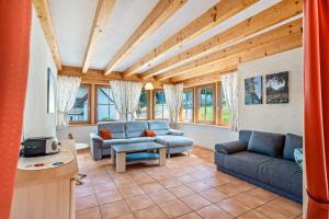 a living room with two blue couches and a table at Löcherhansenhof in Bad Peterstal-Griesbach