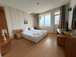 a hotel room with a bed and a television at Хотел Черно море in Sveti Vlas