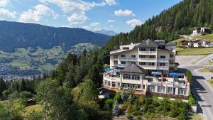 a large building on the side of a mountain at Wellness Aparthotel Panorama Alpin - Ferienwohnungen Jerzens im Pitztal in Jerzens