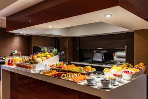 a buffet line with many different types of food at NH Collection Bogota Andino Royal in Bogotá