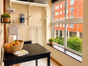 a kitchen with a table and a window at Porto Nest in Senhora da Hora