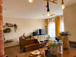 a living room with a table and a dining room at Porto Nest in Senhora da Hora