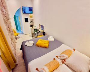 a bedroom with a bed with yellow towels on it at TRAVELLERS CORFU TOWN Luxury Suites, Studios & Apartments in Ágios Rókkos