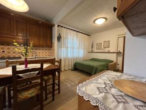 a kitchen and living room with a bed and a table at Agriturismo Signorini in Orciatico