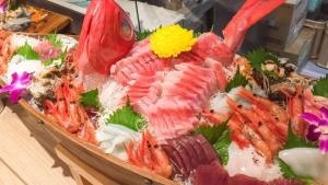 a display of seafood in a tray on a table at Livemax Resort Hachimantai Forest in Hachimantai