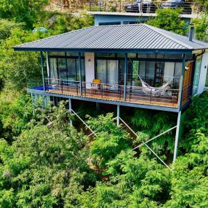 a house with a porch and a hammock in the trees at Alaçam Tatil Evleri in Trabzon