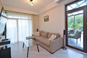 a living room with a couch and a glass table at Domel Tsaghkadzor in Tsaghkadzor