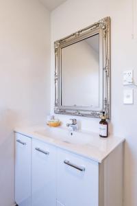 a bathroom with a sink and a mirror at #2 Glenorchy Alpine Suite in Glenorchy