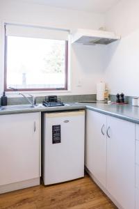 a kitchen with a sink and a refrigerator at #2 Glenorchy Alpine Suite in Glenorchy +30 photos