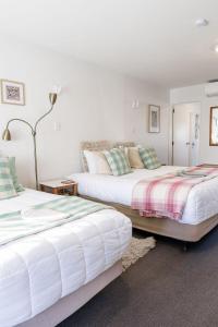 two beds sitting next to each other in a bedroom at #2 Glenorchy Alpine Suite in Glenorchy