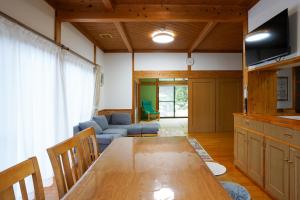 a living room with a table and a couch at くつろ郷Kutsuro-go in Kawatana