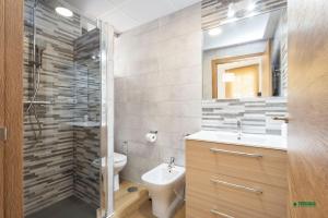 a bathroom with a toilet and a sink and a shower at Habitaciones Martín in San José +38 photos