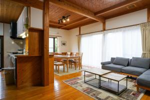 a living room with a couch and a table at くつろ郷Kutsuro-go in Kawatana