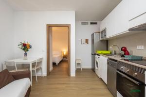 a kitchen with a couch and a table in a room at Habitaciones Martín in San José