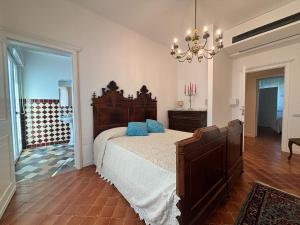 a bedroom with a large bed and a chandelier at Relais Casa Spanu in Dorgali
