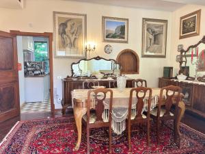 a dining room with a table and chairs and a mirror at Relais Casa Spanu in Dorgali