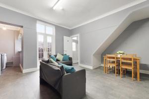 a living room with a couch and a table at 4BR Mitchell Street Apartment Sleeps 6 by Stay With Us in Shield Row