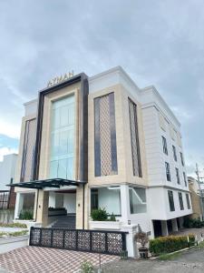 a building with a fence in front of it at AYMAN SYARIAH HOTEL in Surabaya