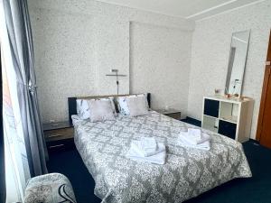 a bedroom with a bed with two towels on it at Velonia Guest House in Sozopol