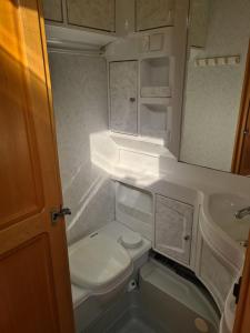 a small bathroom with a toilet and a sink at Chałupy 3 VisitHel in Chałupy