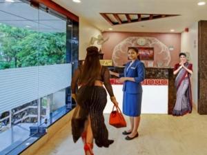 two women standing in front of a counter at Hotel Taj Venture Agra in Agra