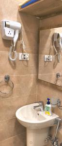a bathroom with a sink and a phone on the wall at Temple & Nile view in Luxor +33 photos