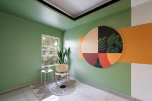 a room with a chair and a painting on the wall at Cove Limora in Bandung