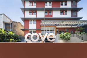 a red building with a love sign in front of it at Cove Limora in Bandung